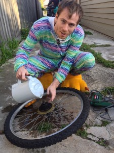 Sam fixing a sticky freewheel with boiling water. We made do with what we had! Never mind the outfit =)